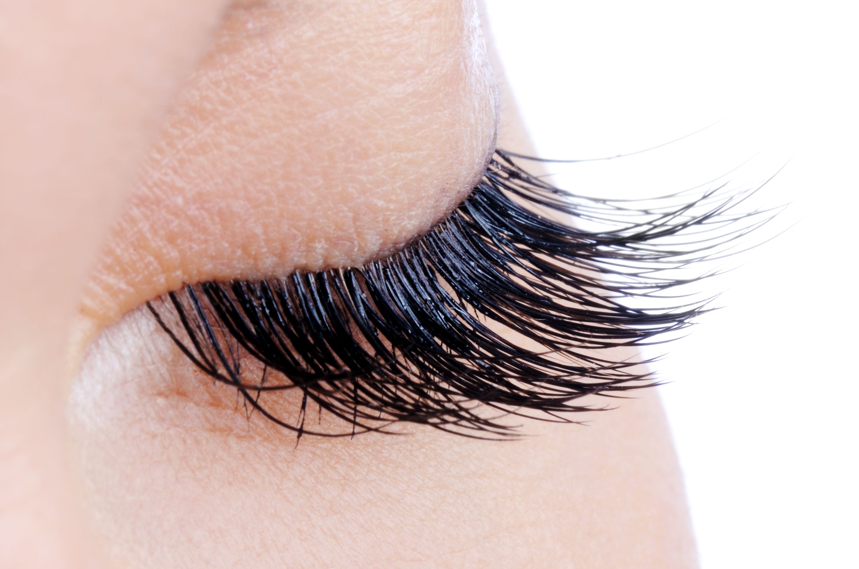 Macro shot of a female eye with long false eyelashes